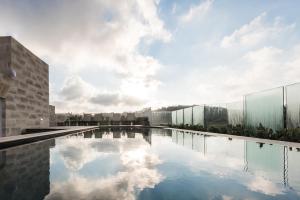 a swimming pool on the roof of a building at Cesca's Boutique Hotel in Xlendi