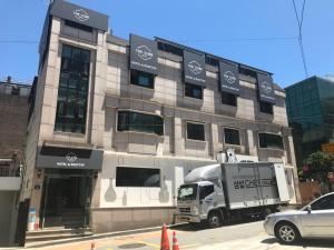 a ups truck parked in front of a building at The Cube Hotel in Seoul