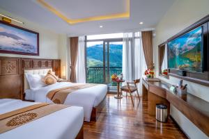 Postel nebo postele na pokoji v ubytování Sapa Relax Hotel & Spa