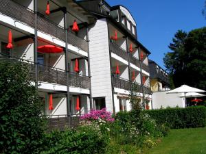 a building with red flags on the side of it at Hotel Haus Katharina garni in Bad Steben