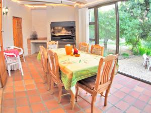 a dining room with a table and chairs and a kitchen at Elly's Place B&B in Darling