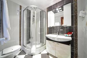 a bathroom with a shower, toilet and sink at Antea Palace Hotel & Spa in Istanbul