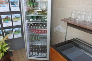 a refrigerator filled with lots of bottles of soda at Hotel Nysted Havn in Nysted +37 photos