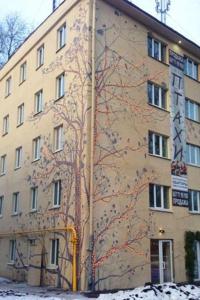 a building with a tree painted on the side of it at Smart apartment проспект Гагарина in Dnipro