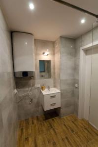 a bathroom with a sink and a shower at Leśne Zacisze w Nadolu in Nadole