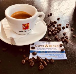a cup of coffee and a bag of coffee beans at Cavo D' Oro in Piraeus
