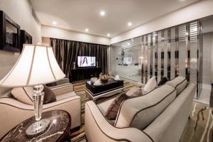 a living room with a couch and chairs and a tv at Al Muhaidb Residence Al Ahsa in Al Ahsa