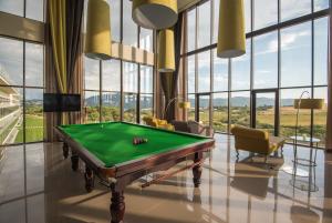 a pool table in a room with windows at Vila Gale Collection Sintra in Sintra
