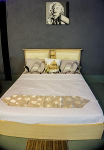 a bedroom with a large bed with a white comforter at Ipoh Boutique Stay in Ipoh