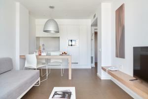 a living room and kitchen with a table and a couch at Ibiza Sun Apartments in Playa d'en Bossa