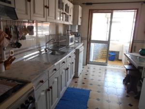 a kitchen with a sink and a counter top at Casa da Isilda in Praia da Barra