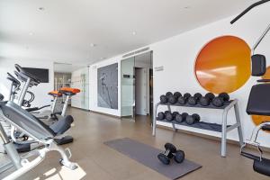 a gym with two tread machines and a mirror at Ibiza Sun Apartments in Playa d'en Bossa