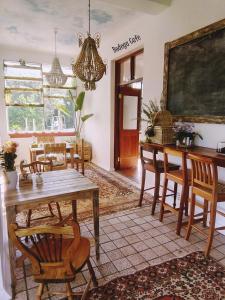 a dining room table and chairs in a room at Shepherd's Tree Backpackers in Knysna
