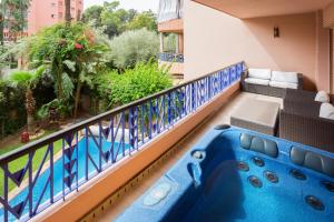 a balcony with a hot tub on a building at The Sapphire Apartment with Private Swimming Pool & Hot Tub - Hivernage Quarter - By Goldex Marrakech in Marrakech