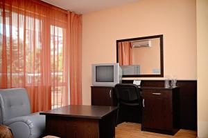 a room with a desk with a tv and a computer at Family Art-Hotel Zora in Vratsa