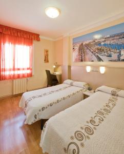 a hotel room with two beds and a painting on the wall at Hostal Barcelona in Barcelona