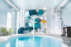 a room with a pool, chairs, and a tub at Best Western Dartmouth Hotel & Suites in Halifax