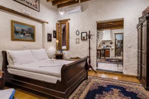 a bedroom with a large bed in a room at Koukos Rhodian Guesthouse - Adults Only in Rhodes Town