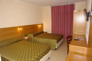 Postel nebo postele na pokoji v ubytování Hotel Corona