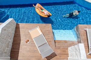 a man in a raft in a swimming pool at Alexandra Beach Spa Resort in Potos