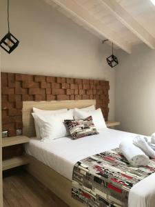a bedroom with a large bed with white pillows at B. U. Luxury Apartments in Asprovalta