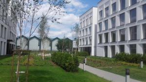 a courtyard of a building next to a building at Platinum Hotel&Residence Wilanów in Warsaw