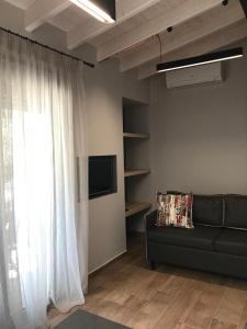 a living room with a couch and a window at B. U. Luxury Apartments in Asprovalta