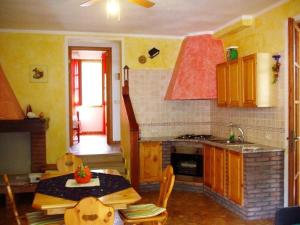 a kitchen with a table and a stove top oven at Villetta a 300mt dal mare Cala Sinzias in Cala Sinzias +4 photos