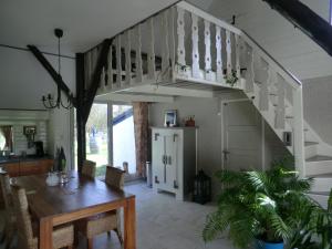 a dining room with a table and a staircase at de Kruik in Blesdijke