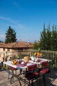 a table and chairs on a deck with food on it at La Vite 2.0 apartments in Desenzano del Garda
