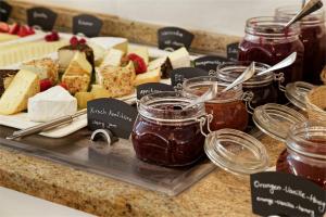 a buffet of jam and desserts on a counter at Wyndham Garden Donaueschingen in Donaueschingen