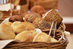 a basket filled with different types of bread at Wyndham Garden Donaueschingen in Donaueschingen