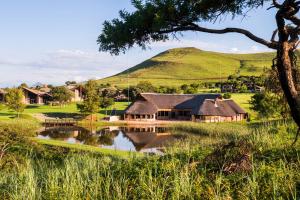 a house in a field with a mountain in the background at aha Alpine Heath Resort in Bonjaneni