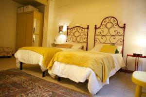 Ліжко або ліжка в номері Le Gemme di Pigna