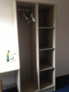 a book shelf in a room with someonesagents at Hôtel La Tour D'Auvergne in Pont-lʼAbbé