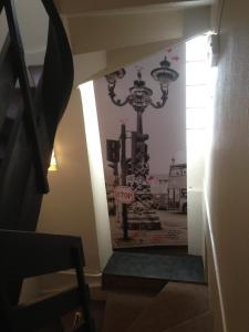 a stairway with a chandelier on the wall at Hôtel La Tour D'Auvergne in Pont-lʼAbbé