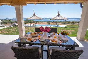 a table with food and flowers on a patio at Estate Villa Duo in Biograd na Moru