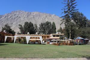 ein Gebäude mit einem Zelt und einem Berg im Hintergrund in der Unterkunft Centro Campestre Qawisqa in Cieneguilla