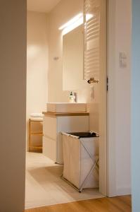 a white bathroom with a sink and a mirror at Bursztynowa 23 in Jelitkowo