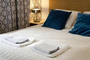 a bed with two towels on top of it at Bursztynowa 23 in Jelitkowo