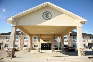 a front view of a building with a garage at Corporate East Hotel in Ulysses