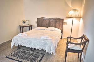 a bedroom with a bed with a table and a chair at Agrihouse in Bracciano