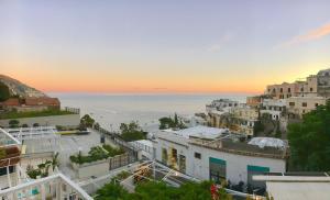 a view of the city of positano at sunset at Hotel Villa Delle Palme in Positano in Positano