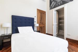 Posteľ alebo postele v izbe v ubytovaní Gramsci Suites