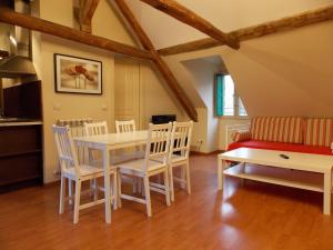 a kitchen and dining room with a table and chairs at Apartamentos Codallos in Tramacastilla de Tena