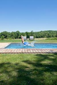 a man is in a swimming pool at Domaine de L'Isle Basse in Fontanes