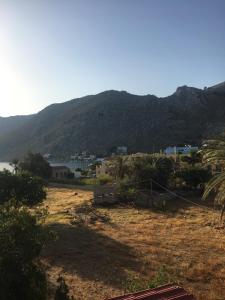 a view of a town with a mountain in the background at "STELIOS & GALINI" in Symi