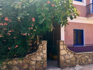 a house with trees and flowers in front of it at "STELIOS & GALINI" in Symi