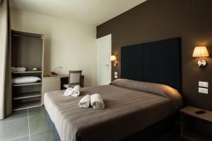 מיטה או מיטות בחדר ב-Garda Guest House