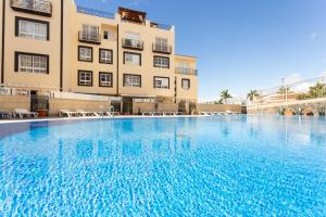 a large swimming pool in front of a building at 190 Duplex La Tosca by Sunkeyrents in Callao Salvaje